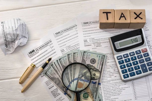 Financial planning desk with documents and a notebook arranged for reviewing household and business financial goals